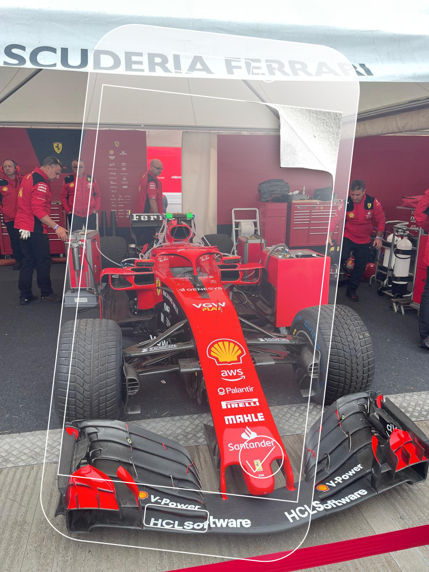 Ferrari F1 car at Scuderia Ferrari event with phone overlay and peeling corner effect